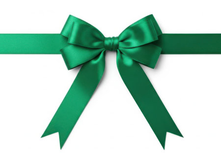 This image features a beautifully tied green ribbon bow, isolated on a white background. The bow is made from shiny, satin-like ribbon with two long tails extending from either side. The image is clean and minimalistic, perfect for various design purposes.の素材