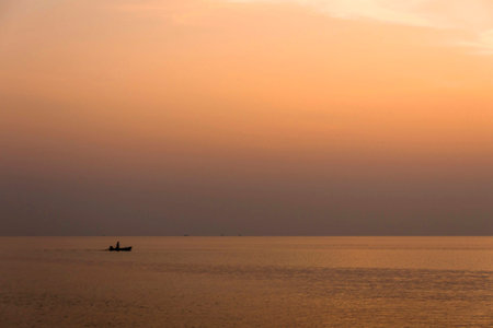 Fishing boat floating on the water at sunset at Koh Kood in Thailand.の写真素材