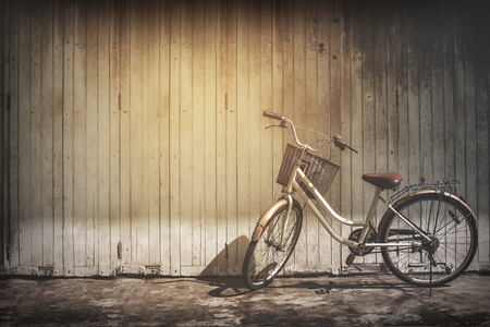 vintage bicycle on vintage wooden house wallの写真素材