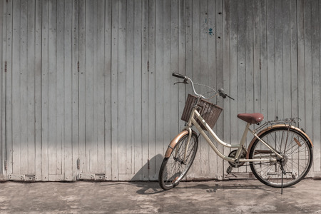 vintage bicycle on vintage wooden house wallの写真素材