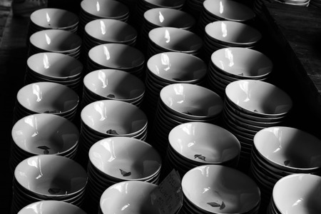Bowls stacked in rows, black and white.の写真素材