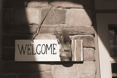 The welcome sign on the door of the old atmosphere.の写真素材