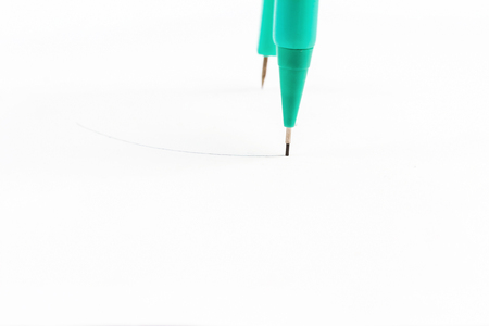pair of compasses drawing circle on a paperの写真素材