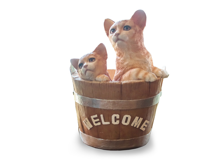 Cats dolls made of ceramic are in the basket,vintage phone , isolated on white background with clipping path.の写真素材