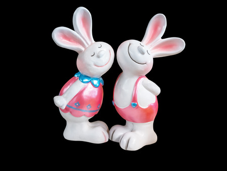 Double rabbit made of ceramic, isolated on black background with clipping pathの写真素材