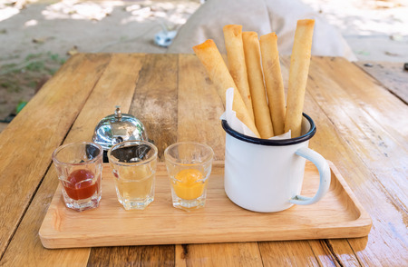 Deep fried spring roll Pour the cream with dipping sauce, desige as an appetizer.の写真素材