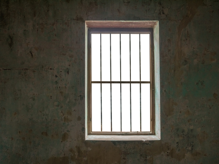 Window with bars against old walls,isolated on white background with clipping path for background images.の写真素材