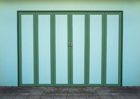Green wooden doors with green walls, vintage style