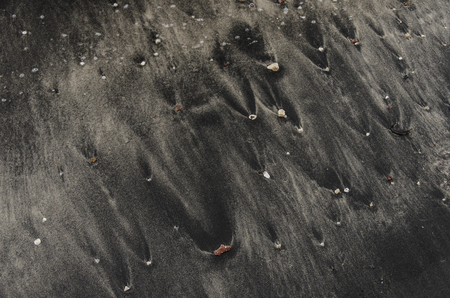 Blury, Movement, Ripples in shallow water over a Black sand Beach, Langkawi, Malaysiaの写真素材