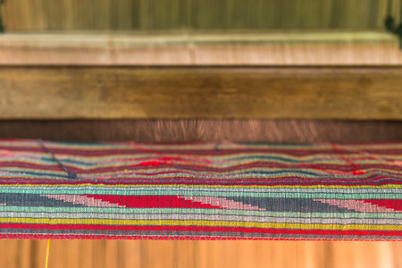 Weaving loom and shuttle on the warp.