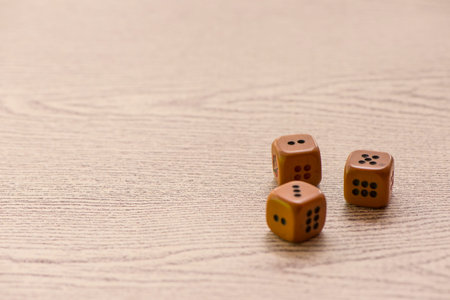 Brown dices on wooden background. Concept of luck, chance and leisure fun.の写真素材
