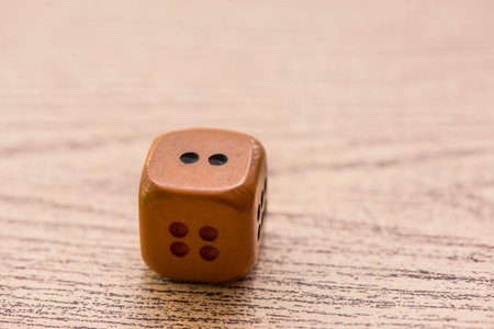 Brown dices on wooden background. Concept of luck, chance and leisure fun./ Sensitive Focus / this...