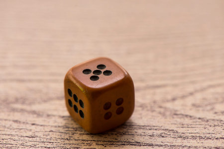 Brown dices on wooden background. Concept of luck, chance and leisure fun./ Sensitive Focus / this dice by handmadeの写真素材