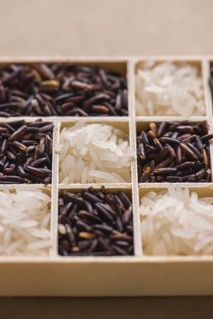 black and white rice in little wood box, Sensitive Focusの写真素材