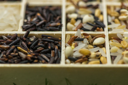 Variety of healthy grains and seeds in a wooden box mostly gluten free with rice, Sensitive Focusの写真素材