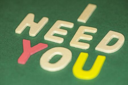 The word spelling to "I need you" on green background, Sensitive Focusの写真素材