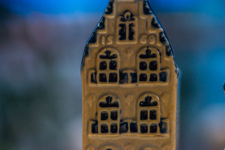 White and blue ceramic souvenir miniature of houses on wood background, Sensitive Focusの写真素材