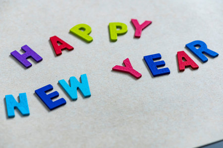 Happy new year font art colorful texting for greeting or celebrate card with light brown background, Sensitive Focusの写真素材