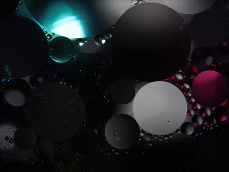 Abstract photography drops of oil on the water. fantastic shapes of colored circles on a colorful...