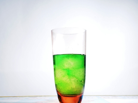 Transparent glass Cup with green drink and ice cubes. Still-life.の写真素材