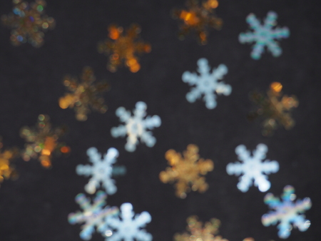 Colorful shiny stars on a black background. Winter background. Background photo.の写真素材