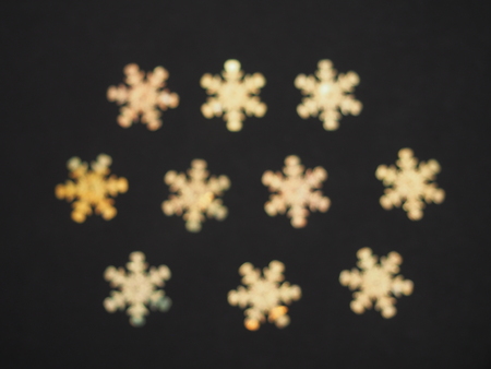 Colorful shiny stars on a black background. Winter background. Background photo.の写真素材