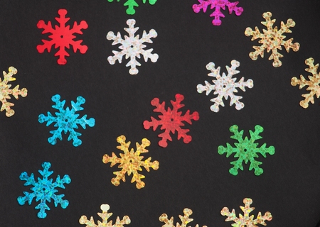 Colorful shiny stars on a black background. Winter background. Background photo.の写真素材