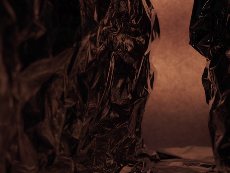 Passage between two rocks. Fantastic landscape of crumpled aluminum foil. Abstract background.の写真素材