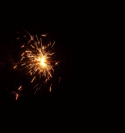 Sparklers in the dark. A sheaf of bright sparks and fire. New year's fireworks.の写真素材