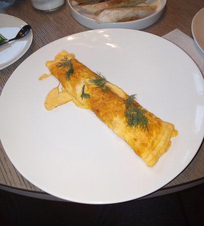 Omelette with greens on a white plate. Breakfast. Photo of food.