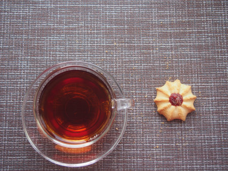 On the table is a glass Cup of tea and there is a huge amount. Still-life