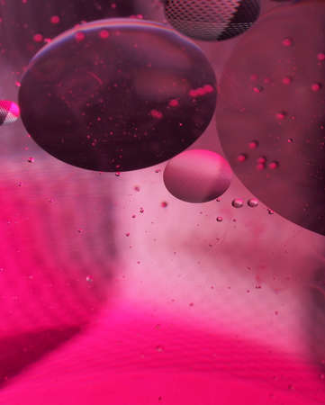 Abstract photography. Multi-colored circles on a multi-colored background. Red, yellow, pink, green, purple circles. Drops of oil on the water. Bokeh. The background photo.の写真素材