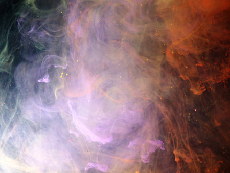 Dissolving paint drops of different colors in water. Red, blue, green, black, purple paint stains in the water. Abstract background.の写真素材