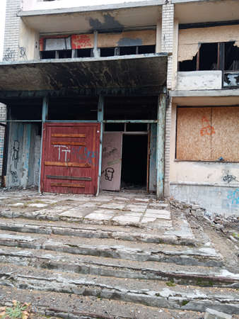 An abandoned building with broken windows and doors. Ruins.の写真素材