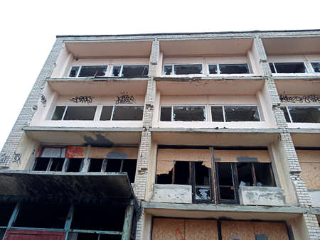 An abandoned building with broken windows and doors. Ruins.の写真素材