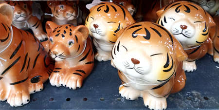 Porcelain tiger figurines lie on the counter. The tiger is the symbol of 2022. Close-upの写真素材