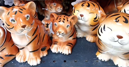 Porcelain tiger figurines lie on the counter. The tiger is the symbol of 2022. Close-upの写真素材