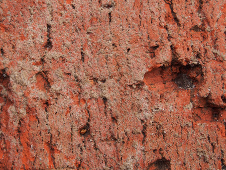 Close-up of a chipped red clay brick. macro photo. texture.の写真素材