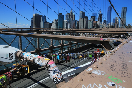 The New York City skyline stands out in the background of the love padlocks on the Brooklyn Bridge on August 23, 2016. (Gordon Donovan)のeditorial素材