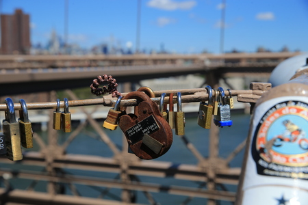 An older style lock hangs a light post on the Brooklyn Bridge on August 23, 2016. (Gordon Donovan)のeditorial素材