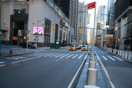 A few people and vehicles can be seen around the empty streets of lower Manhattan near the World...