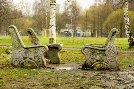 broken benches and trash around in parkの写真素材