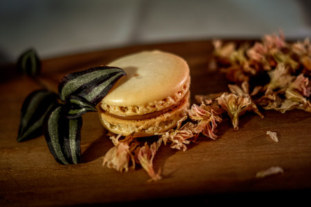 Tasty sweet macaroon cookies on wooden display