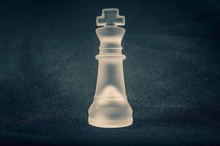 forsted white glass King chess piece on dramatic backgroundの写真素材