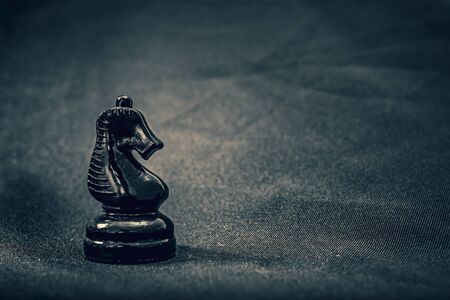 black glass knight chess piece on backgroundの写真素材
