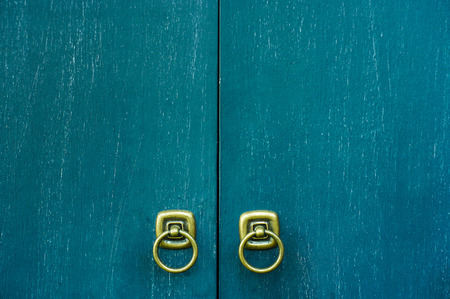 vintage wooden cupboard door with golden holderの写真素材