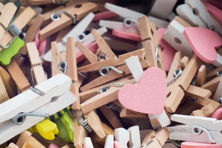many wooden pastel toned clips with heard shaped wooden plank