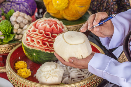hands of artist carving Thai fruitsの写真素材