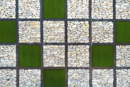 wall made of stone and grass in square shapeの写真素材
