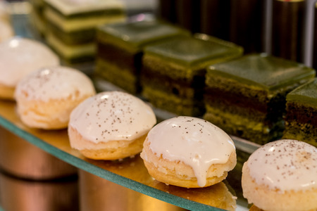 Different sort of beautiful pastry, small colorful sweet cakesの写真素材